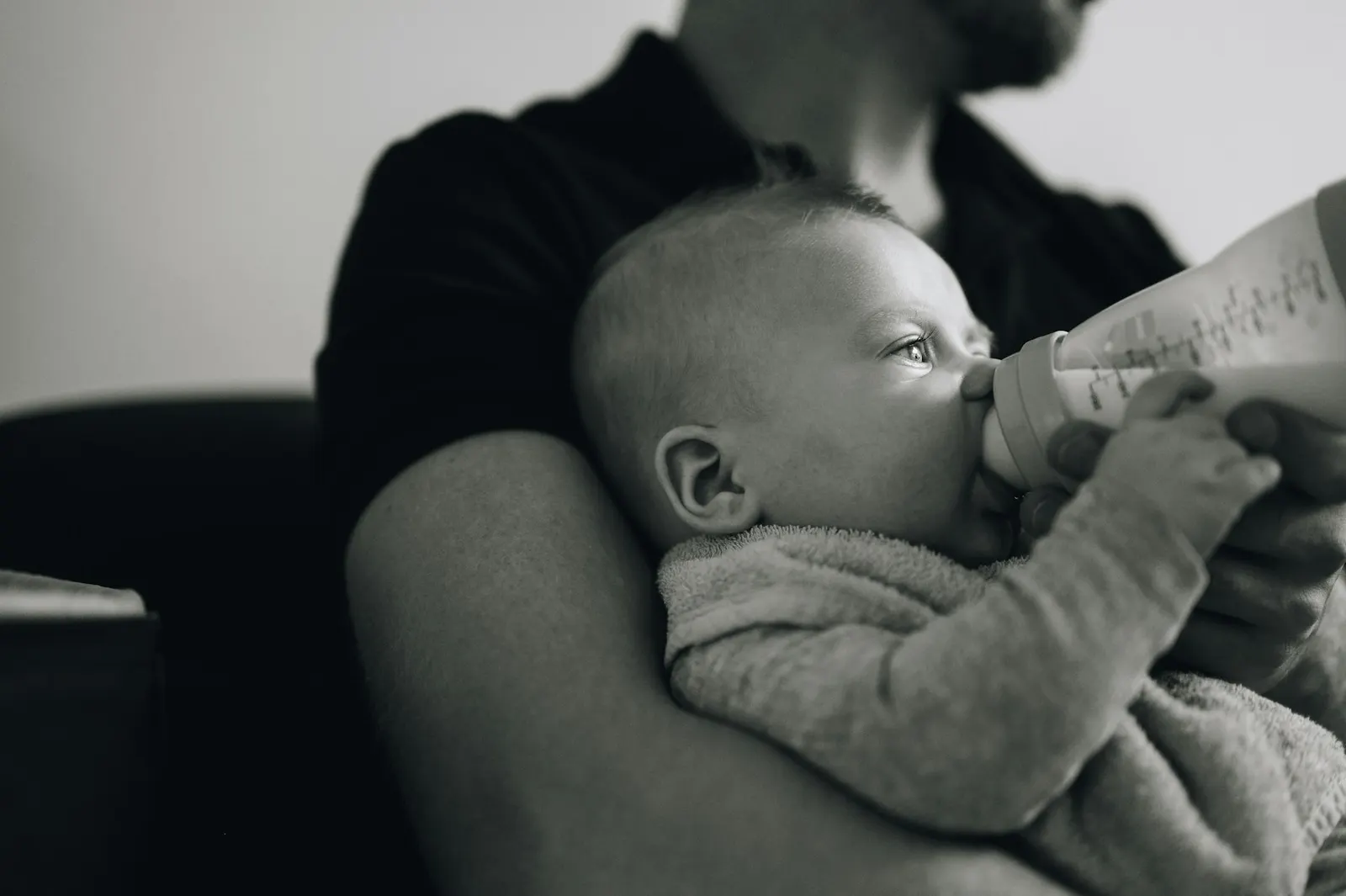 Een vader geeft zijn baby de fles